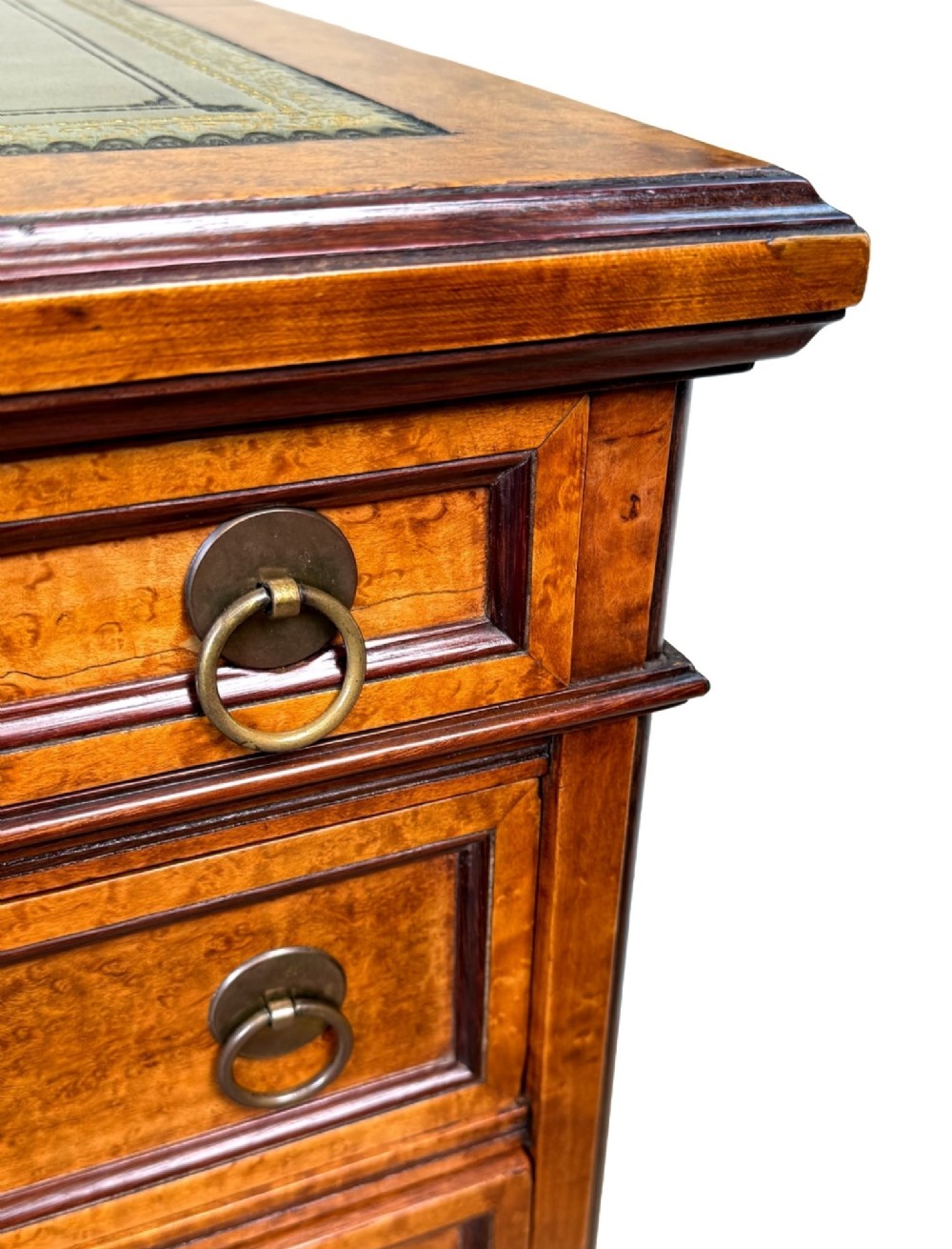 A mid-19th-century English birdseye maple pedestal desk featuring a green leather writing surface, multiple drawers with brass ring drop handles, and a plinth base. View VIII