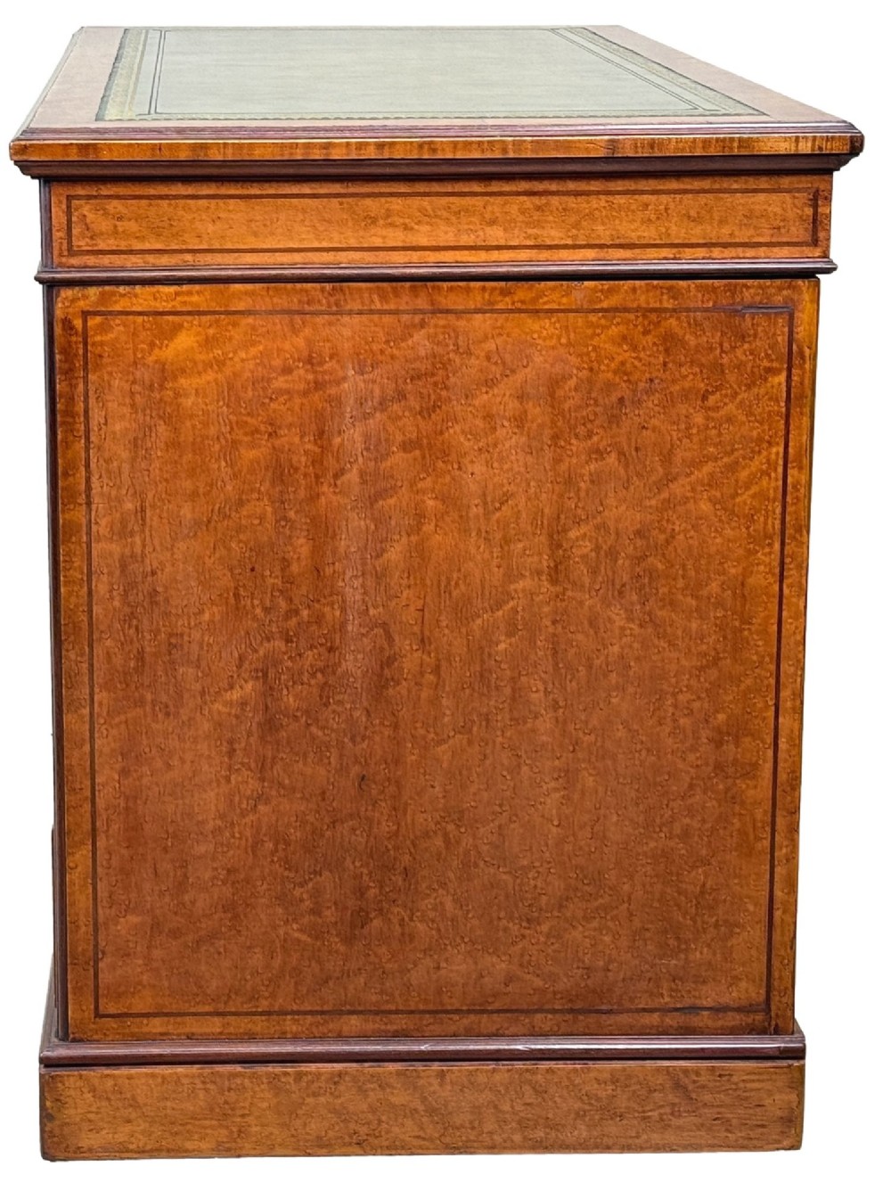A mid-19th-century English birdseye maple pedestal desk featuring a green leather writing surface, multiple drawers with brass ring drop handles, and a plinth base. View IX