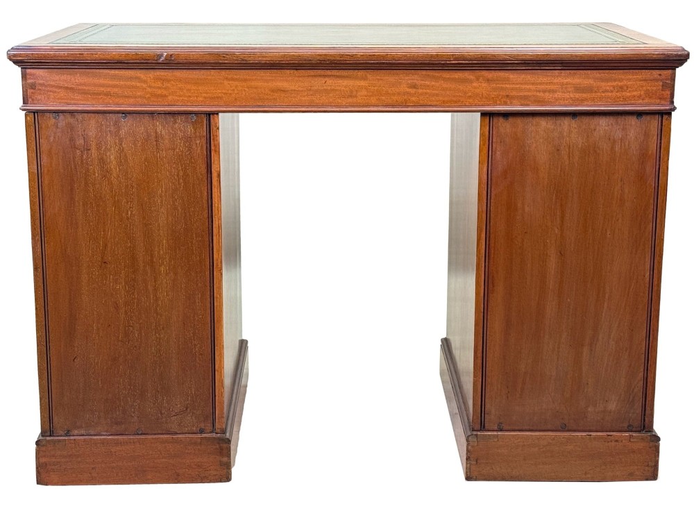 A mid-19th-century English birdseye maple pedestal desk featuring a green leather writing surface, multiple drawers with brass ring drop handles, and a plinth base. View X