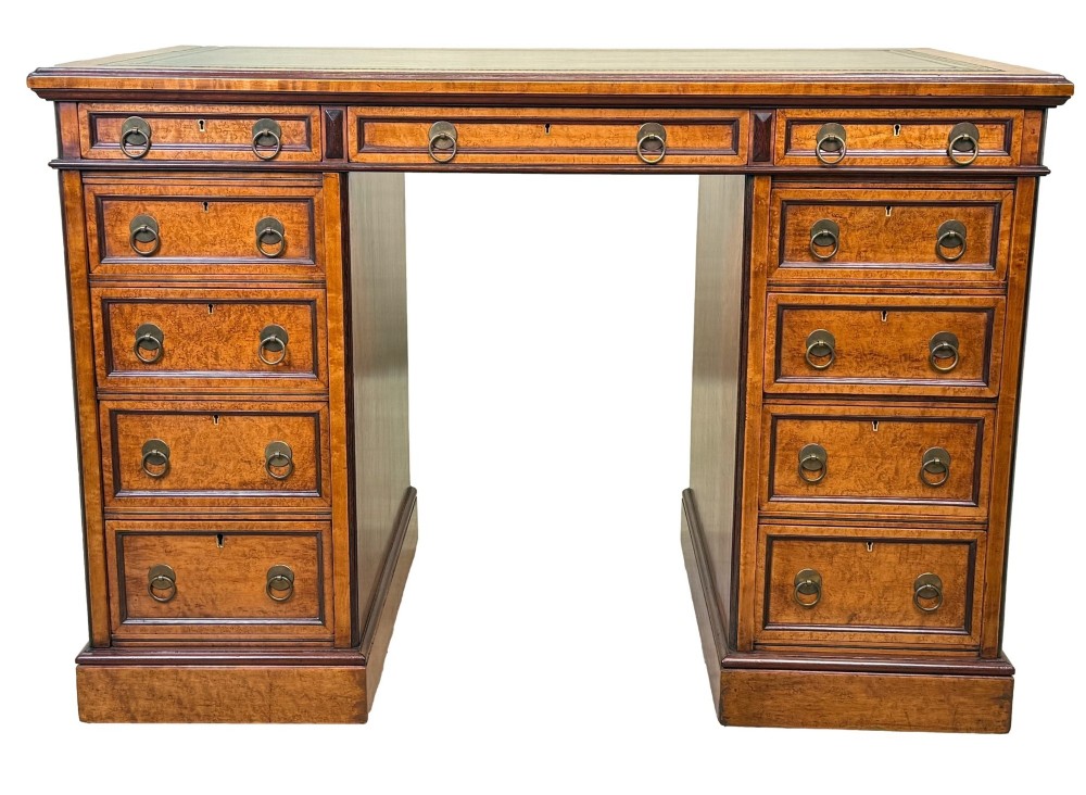 A mid-19th-century English birdseye maple pedestal desk featuring a green leather writing surface, multiple drawers with brass ring drop handles, and a plinth base. View XIII
