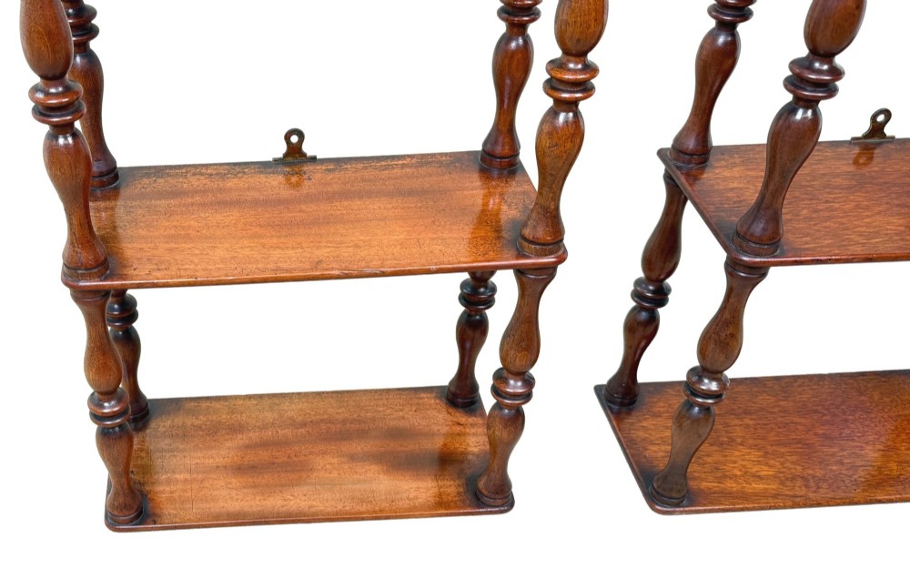 A pair of tall mid-19th-century mahogany wall-hanging shelves featuring five open tiers supported by turned spindles. View V