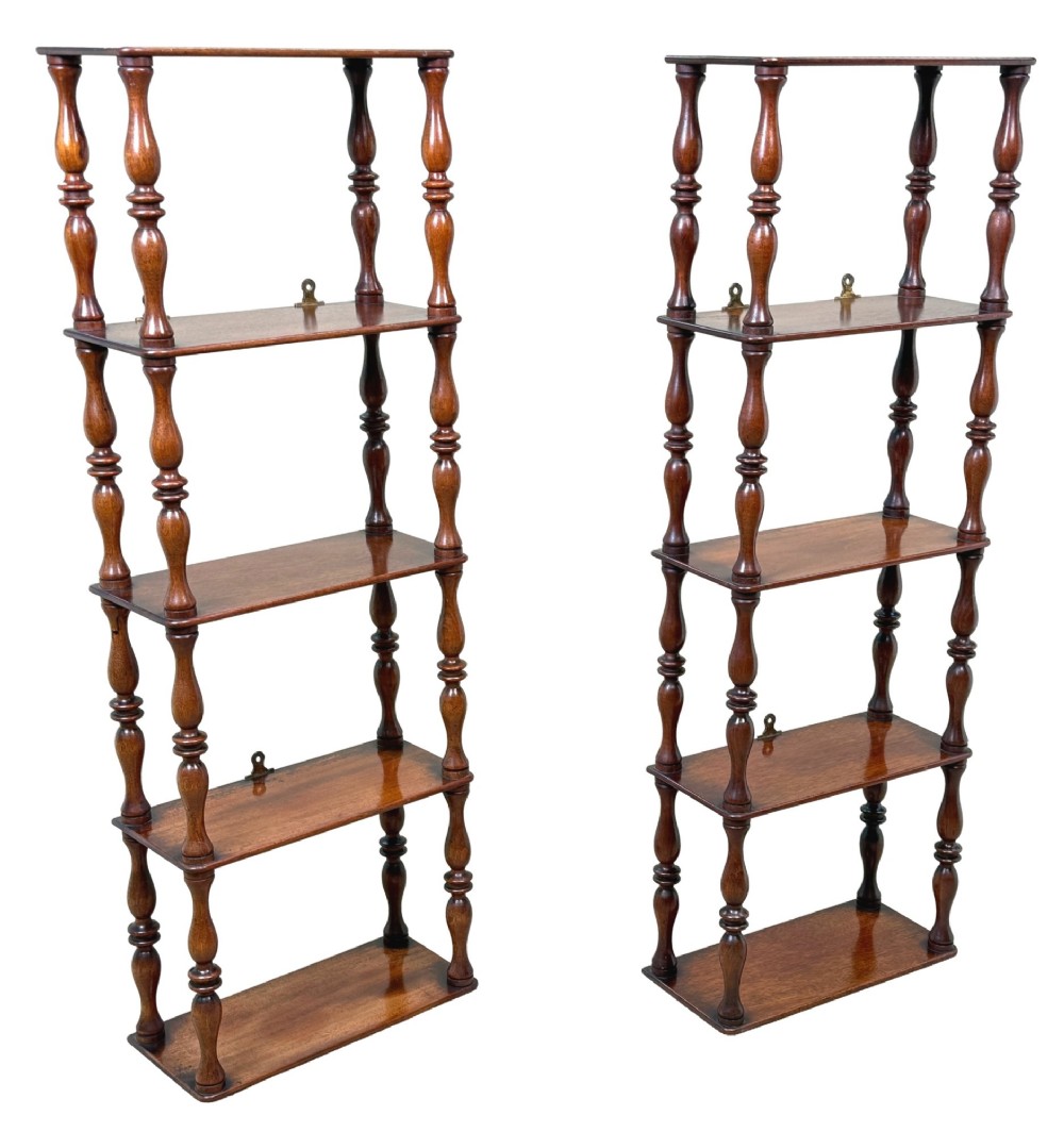 A pair of tall mid-19th-century mahogany wall-hanging shelves featuring five open tiers supported by turned spindles. View VI