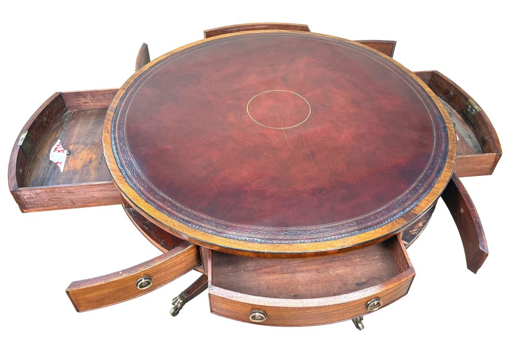 A circular Georgian mahogany drum table featuring a brown leather top, frieze drawers with brass ring handles, and a pedestal base with four splayed legs on brass paw castors. View II