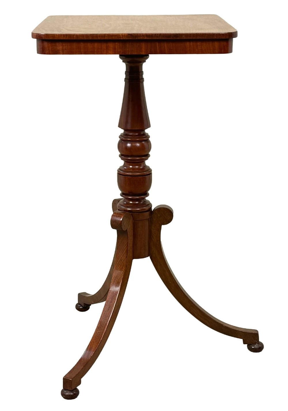 A Regency period mahogany wine table with a rectangular top, a turned central pedestal column, and three splayed legs ending in ball feet. View V