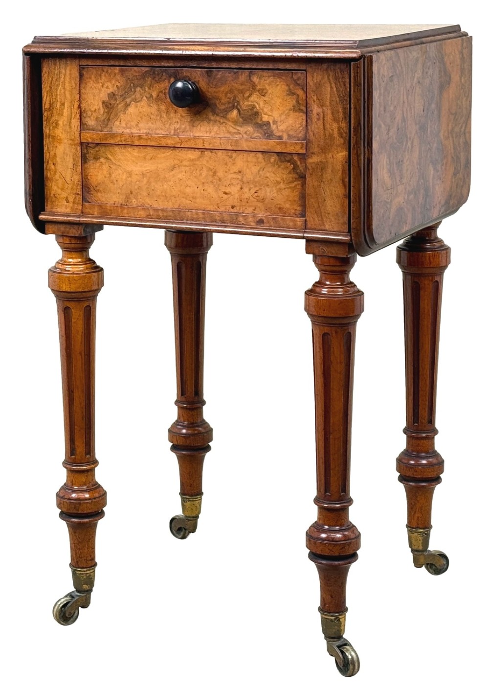 A 19th-century burr walnut Pembroke side table with a single drawer, two drop-down side leaves, turned fluted legs, and brass castors.