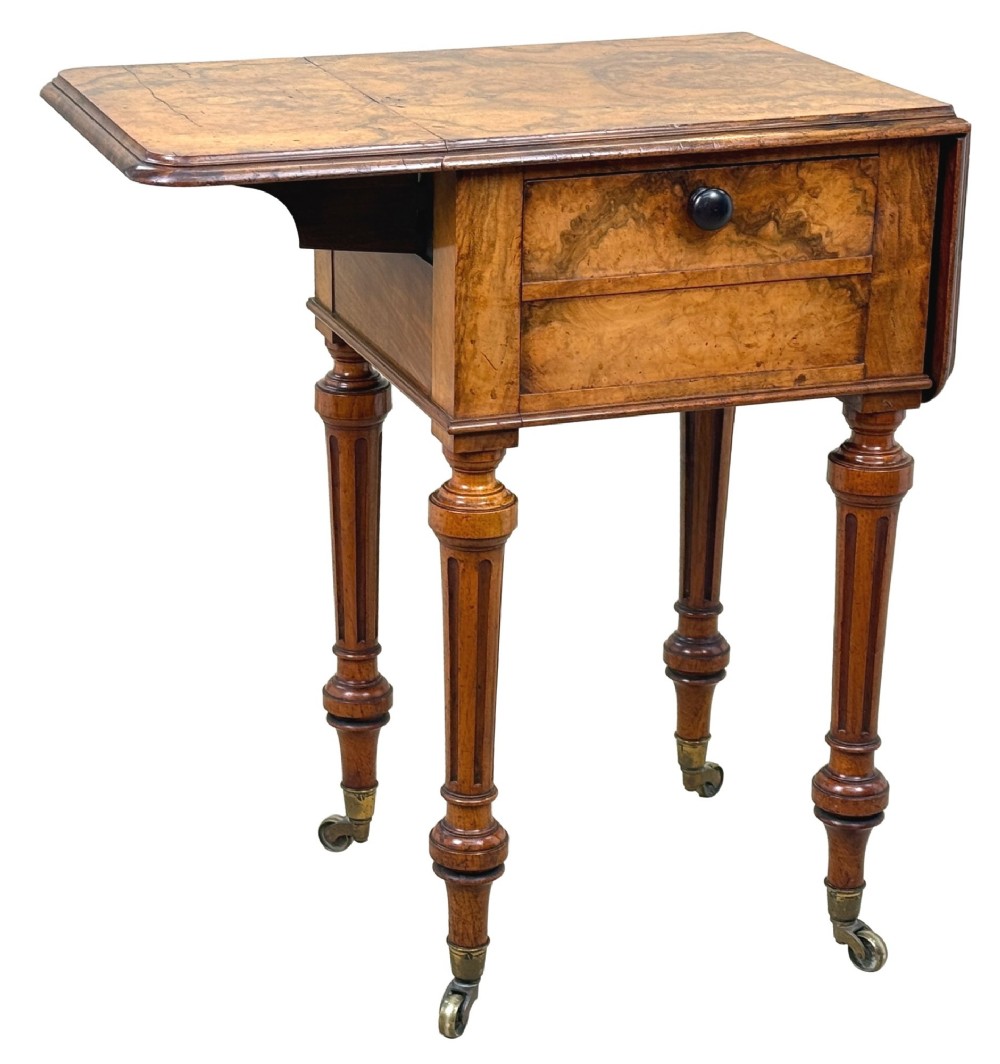 A 19th-century burr walnut Pembroke side table with a single drawer, two drop-down side leaves, turned fluted legs, and brass castors. View IX