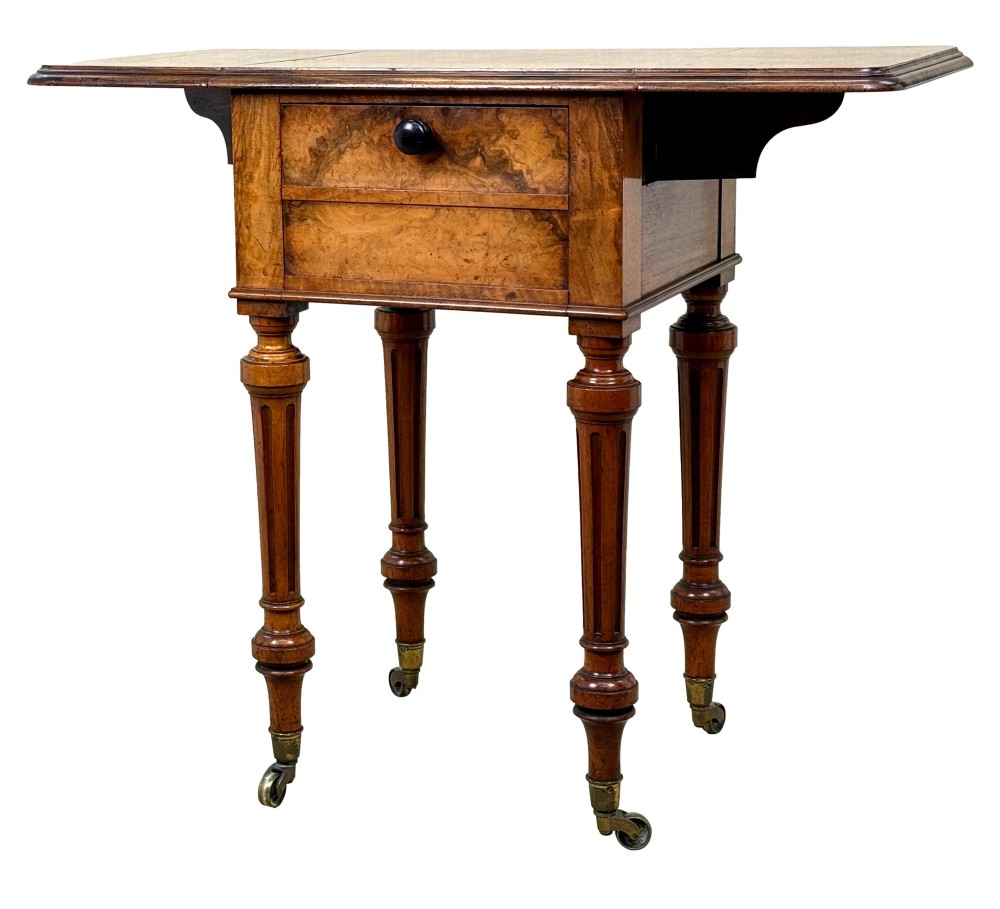 A 19th-century burr walnut Pembroke side table with a single drawer, two drop-down side leaves, turned fluted legs, and brass castors. View XI