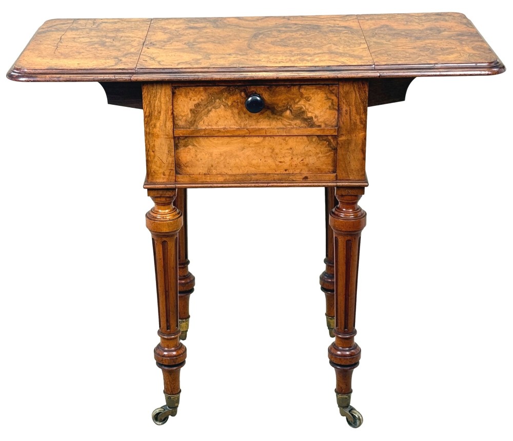 A 19th-century burr walnut Pembroke side table with a single drawer, two drop-down side leaves, turned fluted legs, and brass castors. View XIII