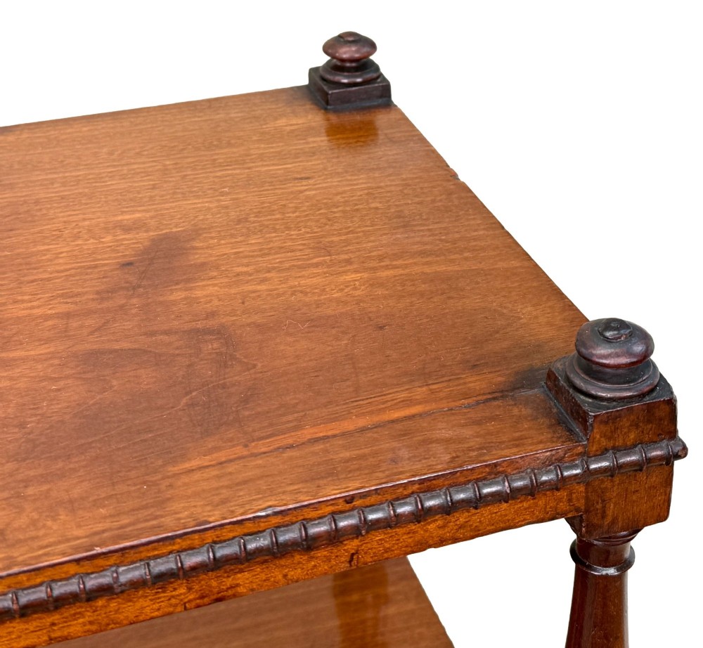 An early nineteenth-century Regency mahogany three-tiered etagere whatnot with turned supports, finials, a lower drawer, and brass castors. View XI