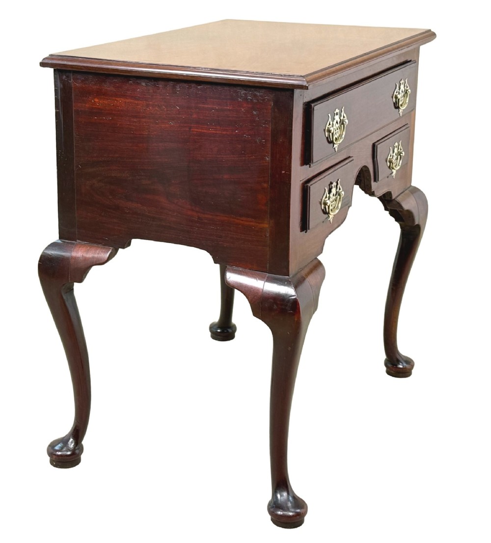 An early Georgian mahogany lowboy table featuring three drawers with brass handles, a shaped apron, and four cabriole legs. View II