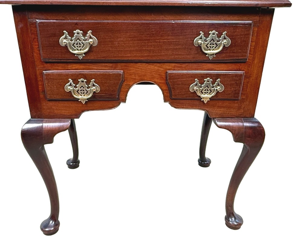 An early Georgian mahogany lowboy table featuring three drawers with brass handles, a shaped apron, and four cabriole legs. View VIII
