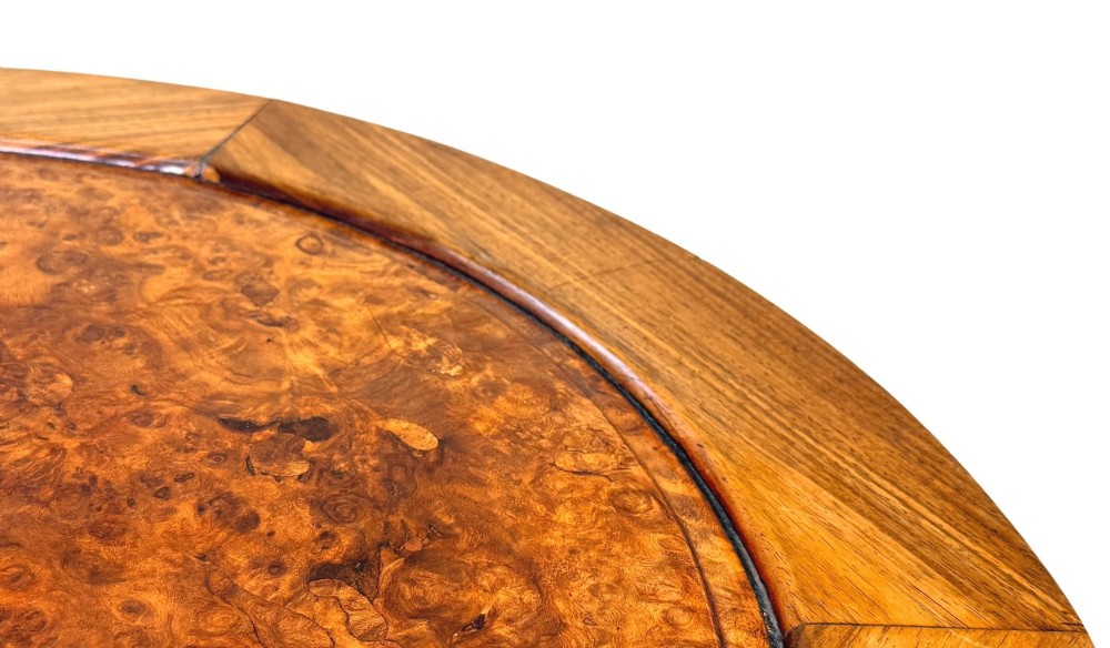 A circular 19th-century Chinese export hardwood coffee table featuring an inset burr wood top, carved scroll aprons, and curved legs. View II