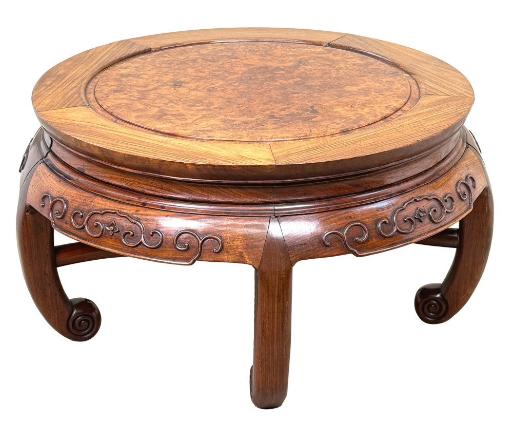 A circular 19th-century Chinese export hardwood coffee table featuring an inset burr wood top, carved scroll aprons, and curved legs. View IV