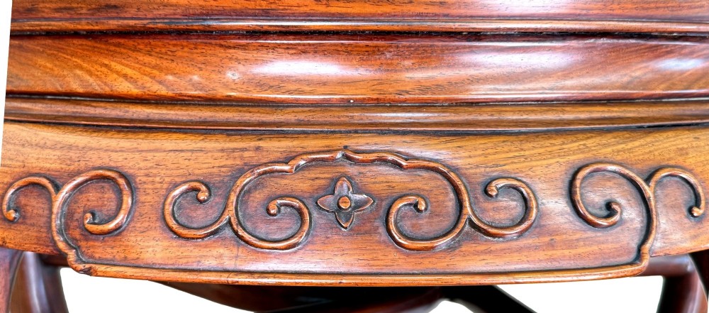 A circular 19th-century Chinese export hardwood coffee table featuring an inset burr wood top, carved scroll aprons, and curved legs. View V