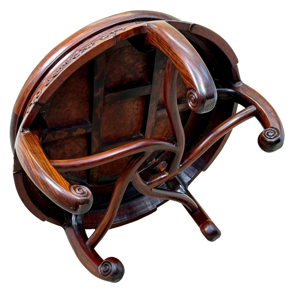 A circular 19th-century Chinese export hardwood coffee table featuring an inset burr wood top, carved scroll aprons, and curved legs. View VII
