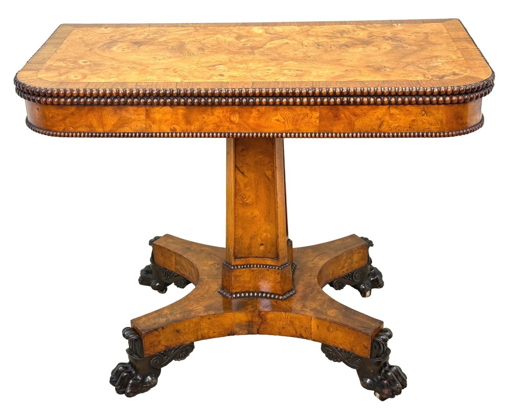 An early 19th-century Regency period pollard oak fold-over tea table featuring a rectangular top, beaded edging, a central pedestal support, and a quadripartite base resting on carved claw feet. View XI