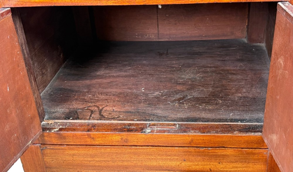 A matched pair of Georgian mahogany bedside tables featuring top tray galleries with cutout handles, double cupboard doors, lower drawers, and brass hardware. View III