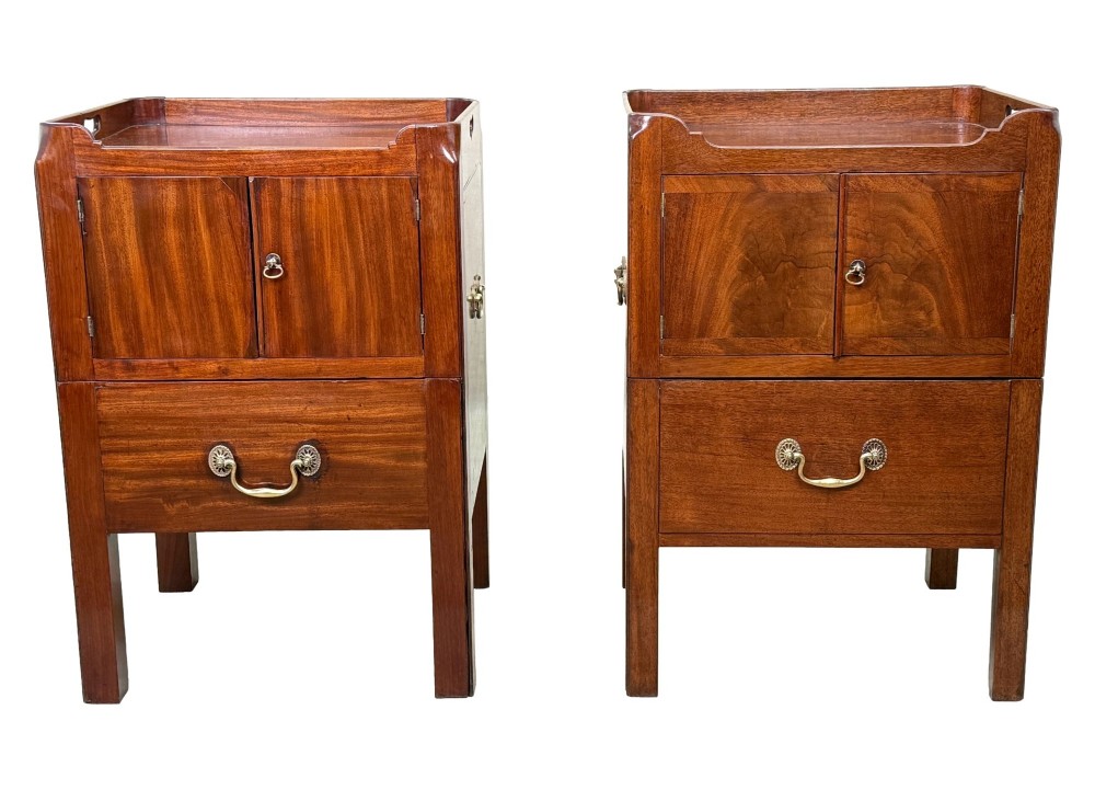 A matched pair of Georgian mahogany bedside tables featuring top tray galleries with cutout handles, double cupboard doors, lower drawers, and brass hardware. View XI