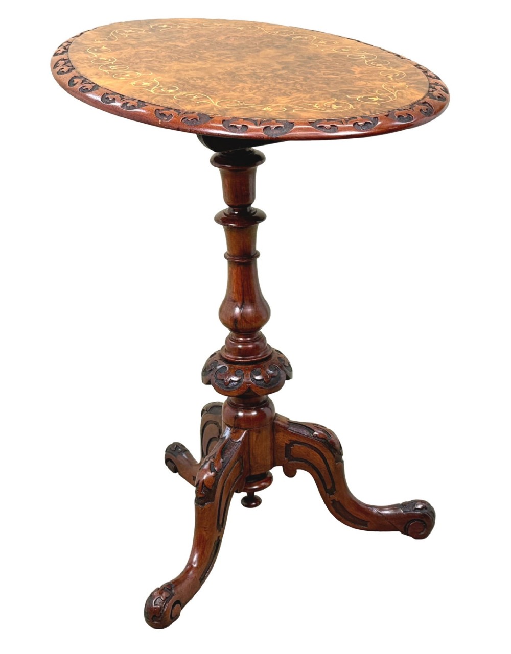 A Victorian burr walnut oval occasional table with marquetry inlay top, a turned central pedestal, and carved tripod cabriole feet. View II