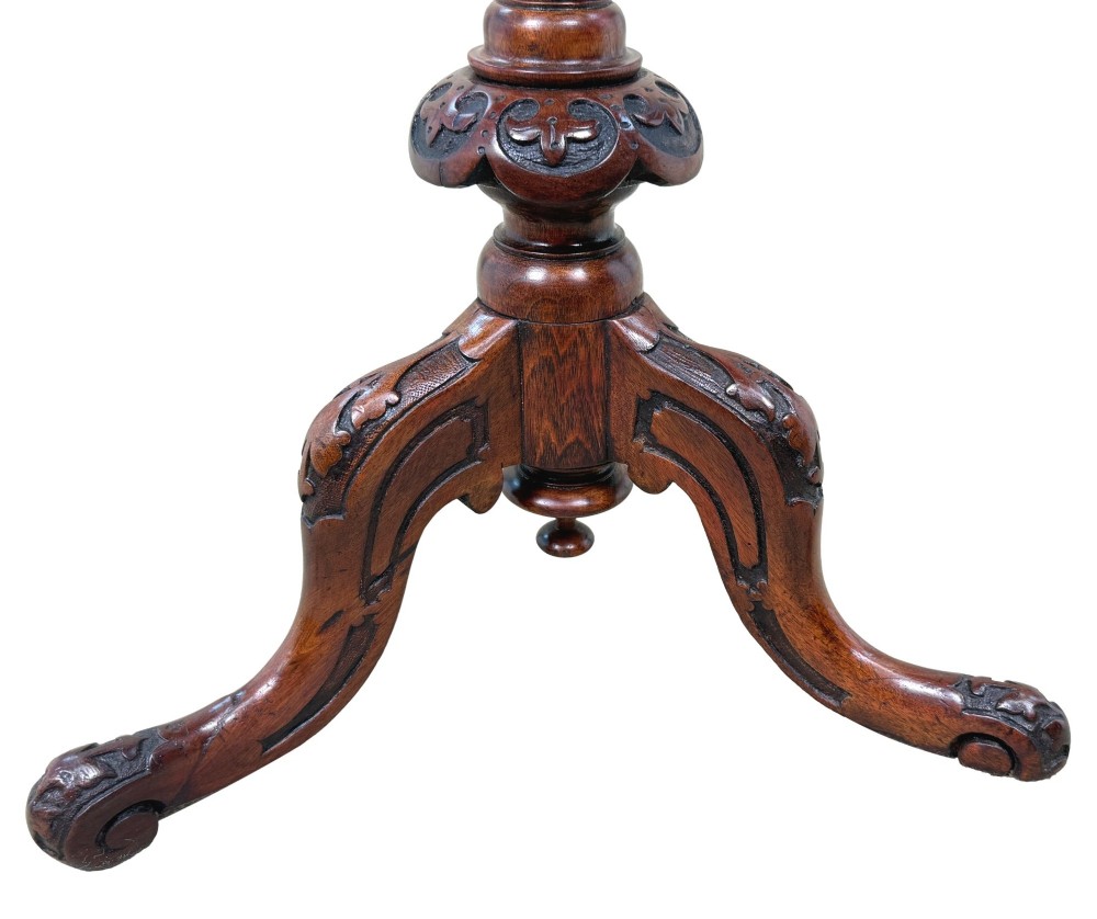 A Victorian burr walnut oval occasional table with marquetry inlay top, a turned central pedestal, and carved tripod cabriole feet. View IV