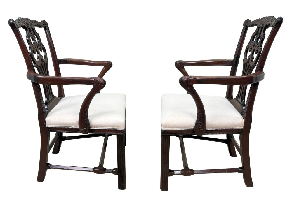 A pair of 18th-century Chippendale mahogany carver armchairs featuring intricately carved pierced back splats, curved arms, and neutral upholstered drop-in seats. View II