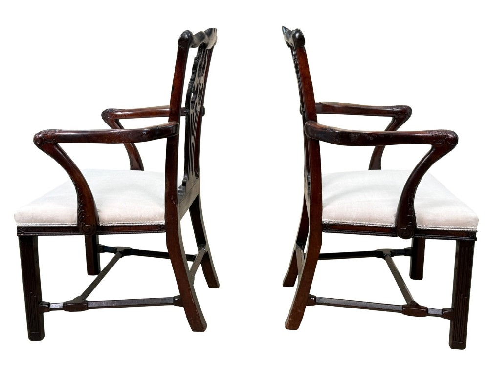 A pair of 18th-century Chippendale mahogany carver armchairs featuring intricately carved pierced back splats, curved arms, and neutral upholstered drop-in seats. View IV