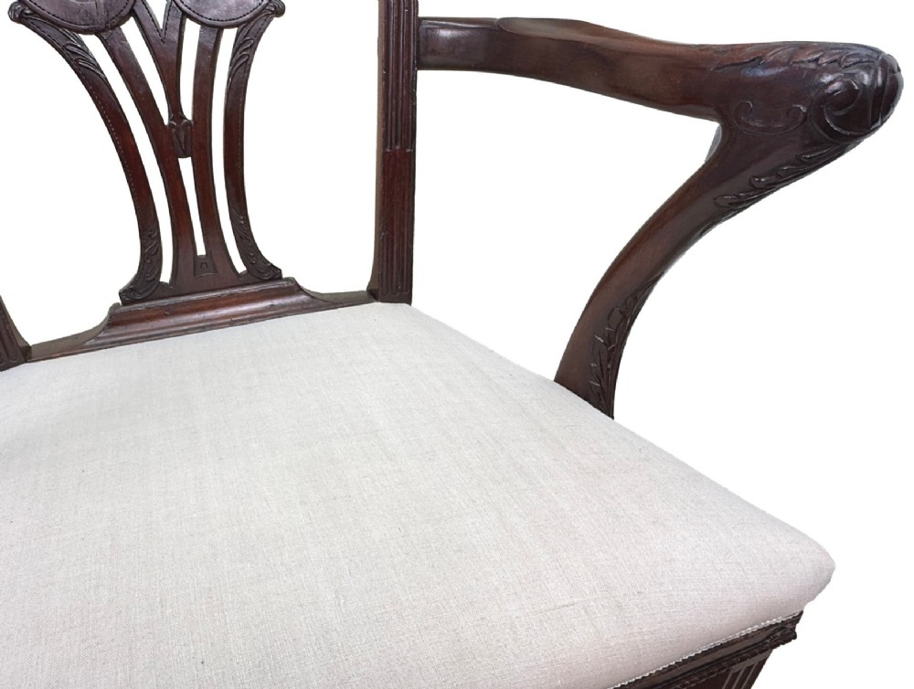 A pair of 18th-century Chippendale mahogany carver armchairs featuring intricately carved pierced back splats, curved arms, and neutral upholstered drop-in seats. View V