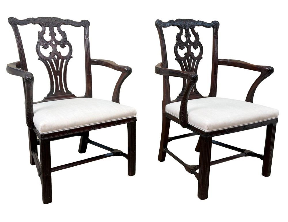 A pair of 18th-century Chippendale mahogany carver armchairs featuring intricately carved pierced back splats, curved arms, and neutral upholstered drop-in seats. View VIII