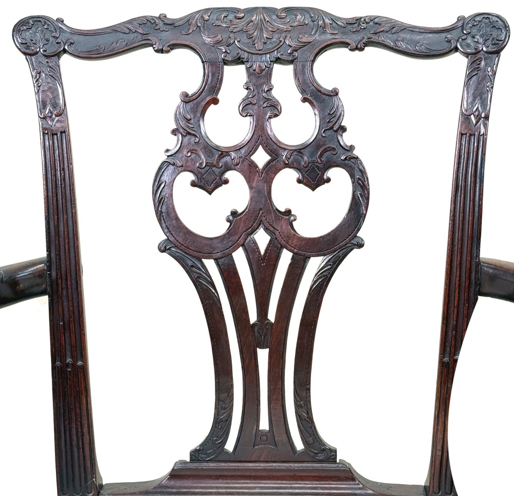 A pair of 18th-century Chippendale mahogany carver armchairs featuring intricately carved pierced back splats, curved arms, and neutral upholstered drop-in seats. View IX