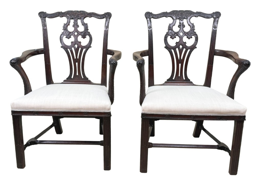 A pair of 18th-century Chippendale mahogany carver armchairs featuring intricately carved pierced back splats, curved arms, and neutral upholstered drop-in seats. View XII