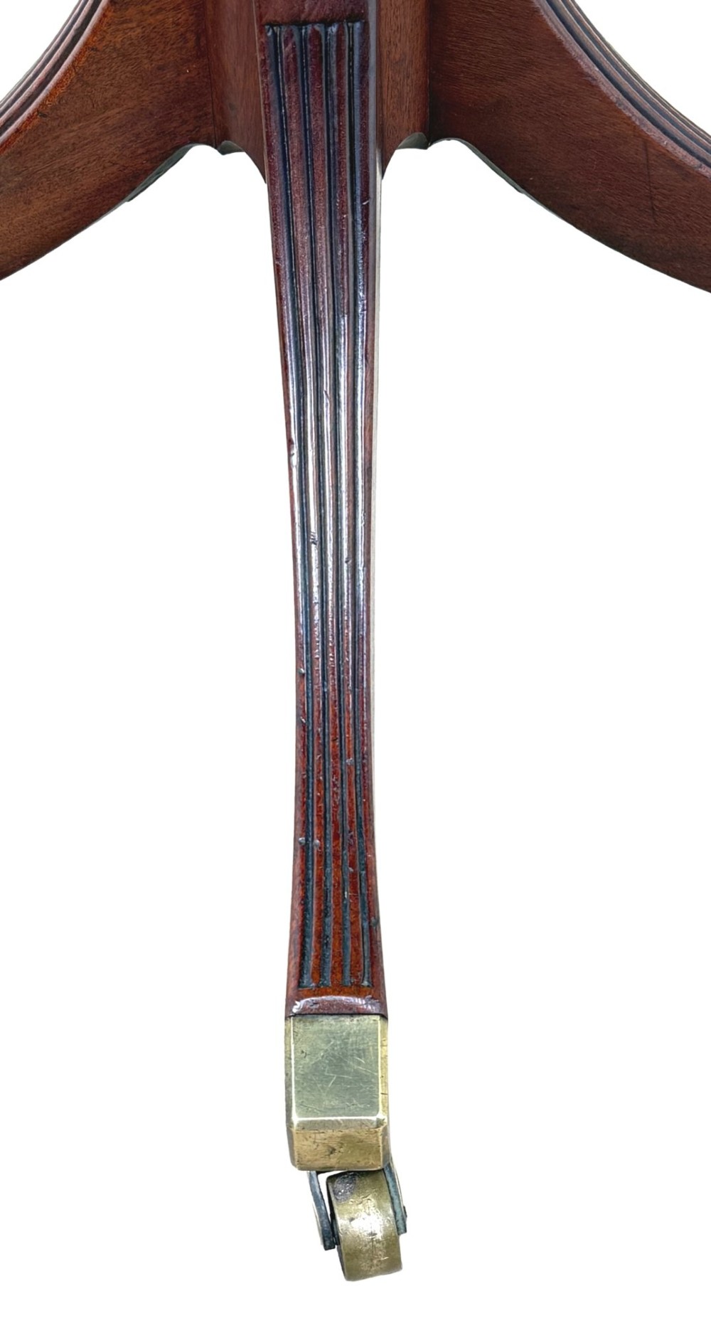Late eighteenth-century George III mahogany circular lamp table featuring a fluted stem and four reeded legs with brass castors. View IV