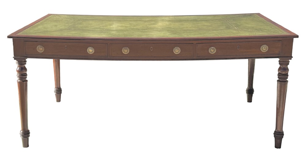 A large 19th-century Georgian mahogany partners writing table with frieze drawers, brass handles, turned legs, and a dark leather writing surface. View VII