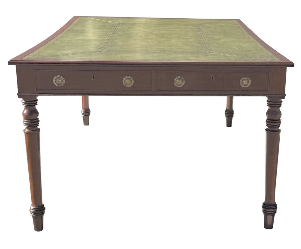 A large 19th-century Georgian mahogany partners writing table with frieze drawers, brass handles, turned legs, and a dark leather writing surface. View IX