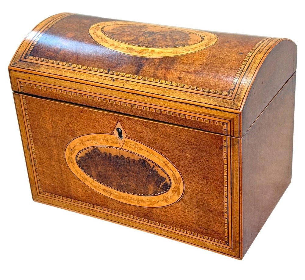 A late 18th-century George III wooden tea caddy featuring a domed lid, intricate marquetry inlay with central oval medallions, and geometric border stringing.