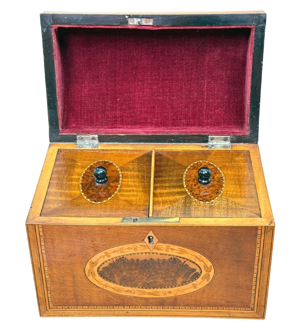 A late 18th-century George III wooden tea caddy featuring a domed lid, intricate marquetry inlay with central oval medallions, and geometric border stringing. View III