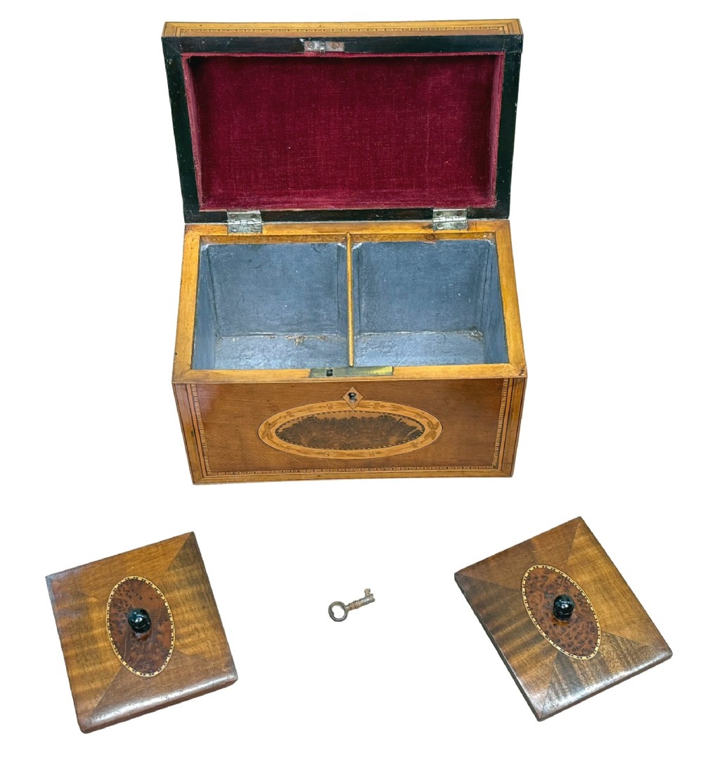 A late 18th-century George III wooden tea caddy featuring a domed lid, intricate marquetry inlay with central oval medallions, and geometric border stringing. View VI