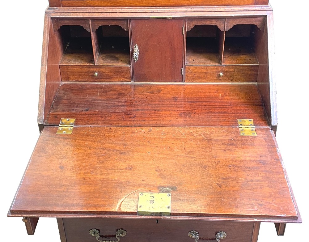 A Georgian mahogany bureau bookcase featuring an upper mirrored cabinet door above a slant-front desk and three lower drawers. View II