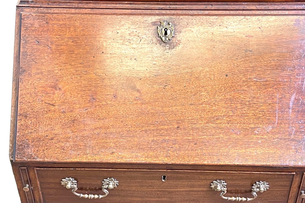 A Georgian mahogany bureau bookcase featuring an upper mirrored cabinet door above a slant-front desk and three lower drawers. View XII