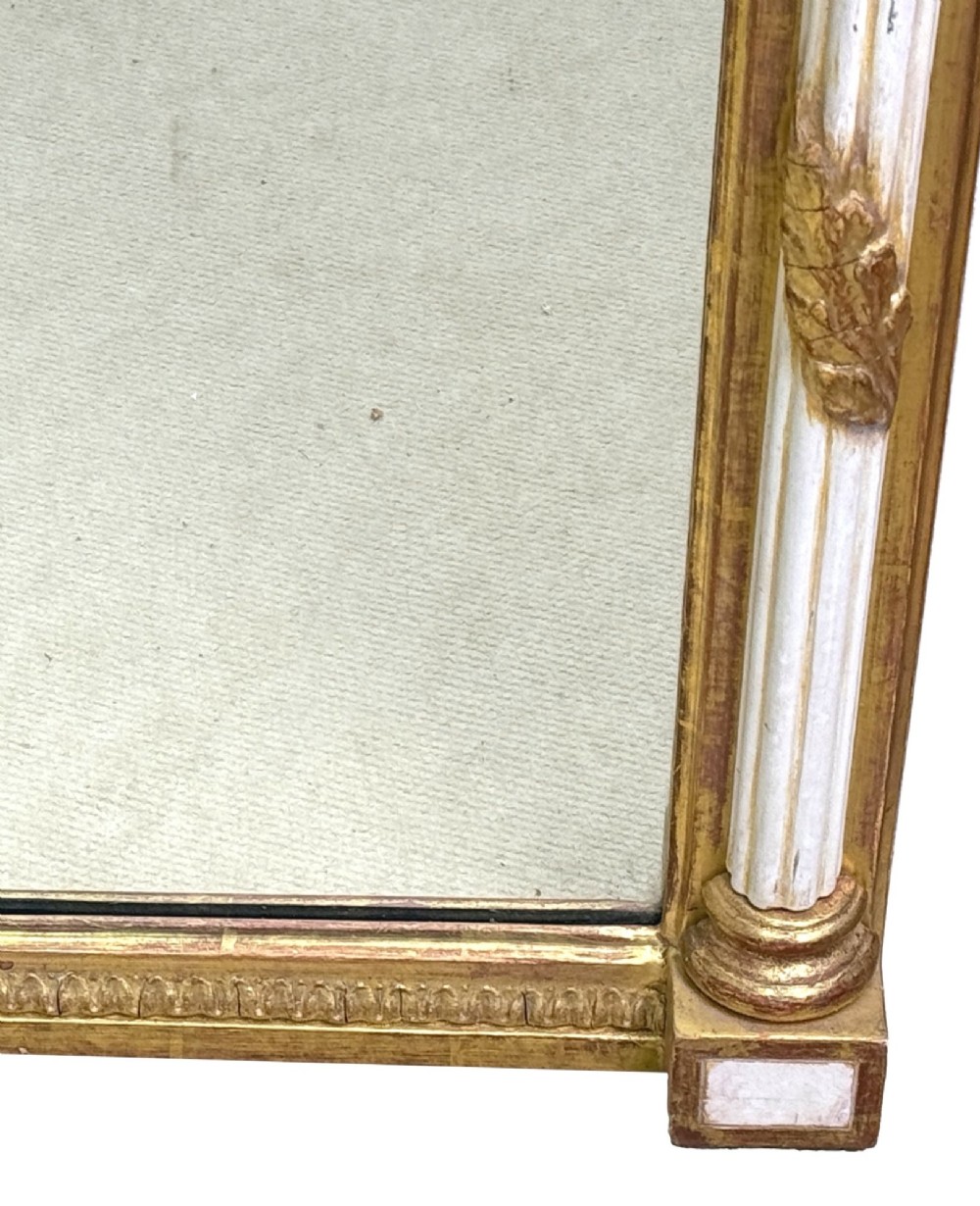 A pair of tall early 19th-century Regency pier mirrors featuring gilded pilasters, breakfront cornices, and upper painted panels depicting maritime sailing vessels. View V
