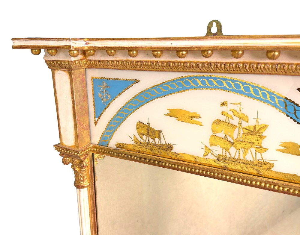 A pair of tall early 19th-century Regency pier mirrors featuring gilded pilasters, breakfront cornices, and upper painted panels depicting maritime sailing vessels. View VII