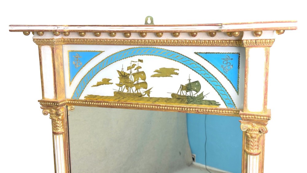 A pair of tall early 19th-century Regency pier mirrors featuring gilded pilasters, breakfront cornices, and upper painted panels depicting maritime sailing vessels. View IX