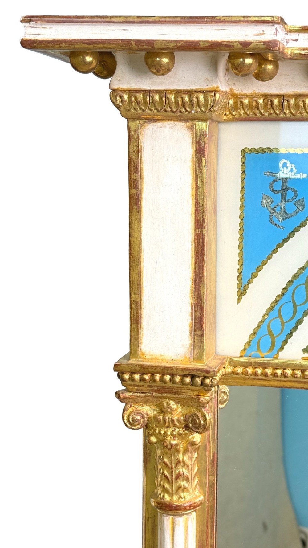 A pair of tall early 19th-century Regency pier mirrors featuring gilded pilasters, breakfront cornices, and upper painted panels depicting maritime sailing vessels. View XI