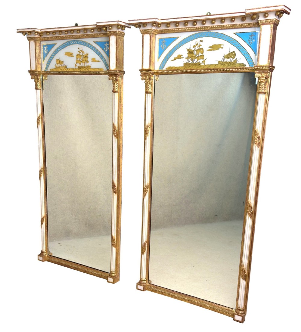 A pair of tall early 19th-century Regency pier mirrors featuring gilded pilasters, breakfront cornices, and upper painted panels depicting maritime sailing vessels. View XIV