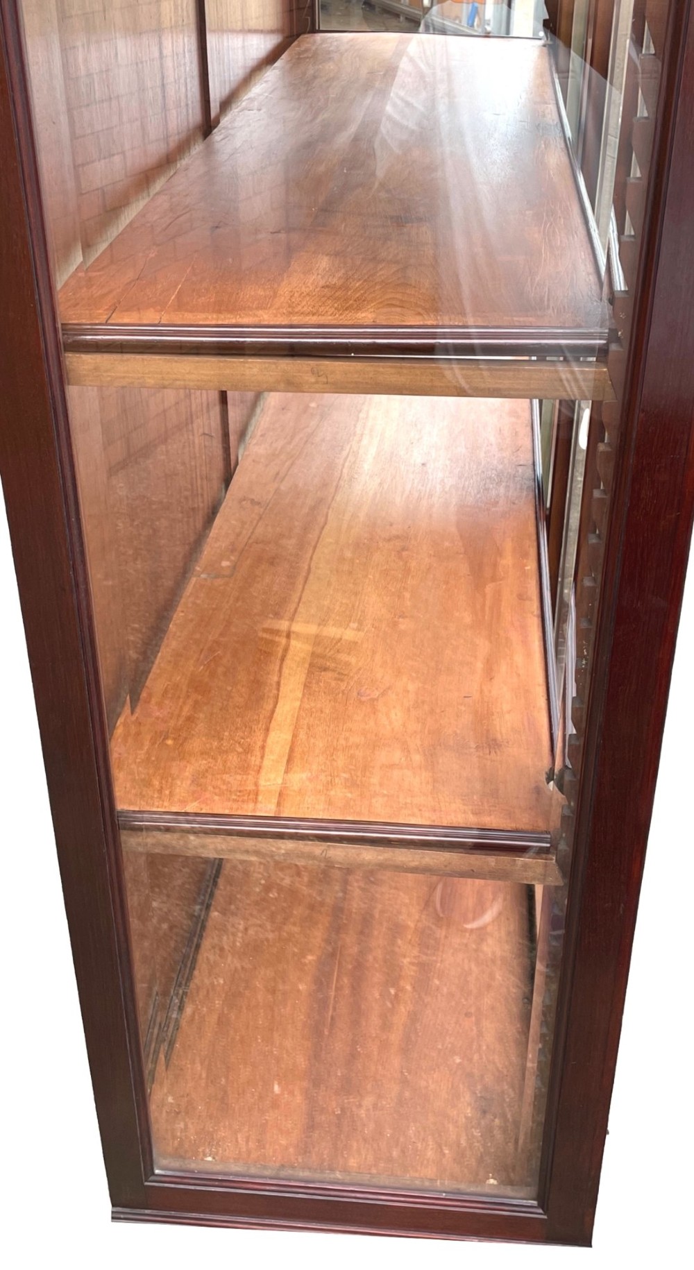 A 19th-century dark mahogany display cabinet featuring a carved crest, glazed doors, and lower support with carved lion mask legs. View V