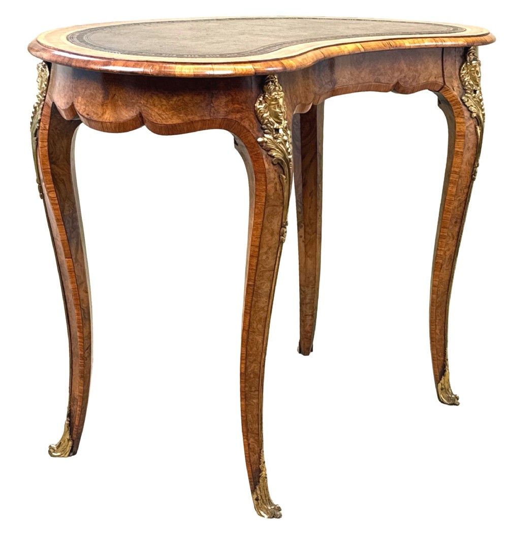 A 19th-century burr walnut kidney-shaped writing table featuring an inset leather top, gilt bronze espagnolette mounts, and cabriole legs. View II
