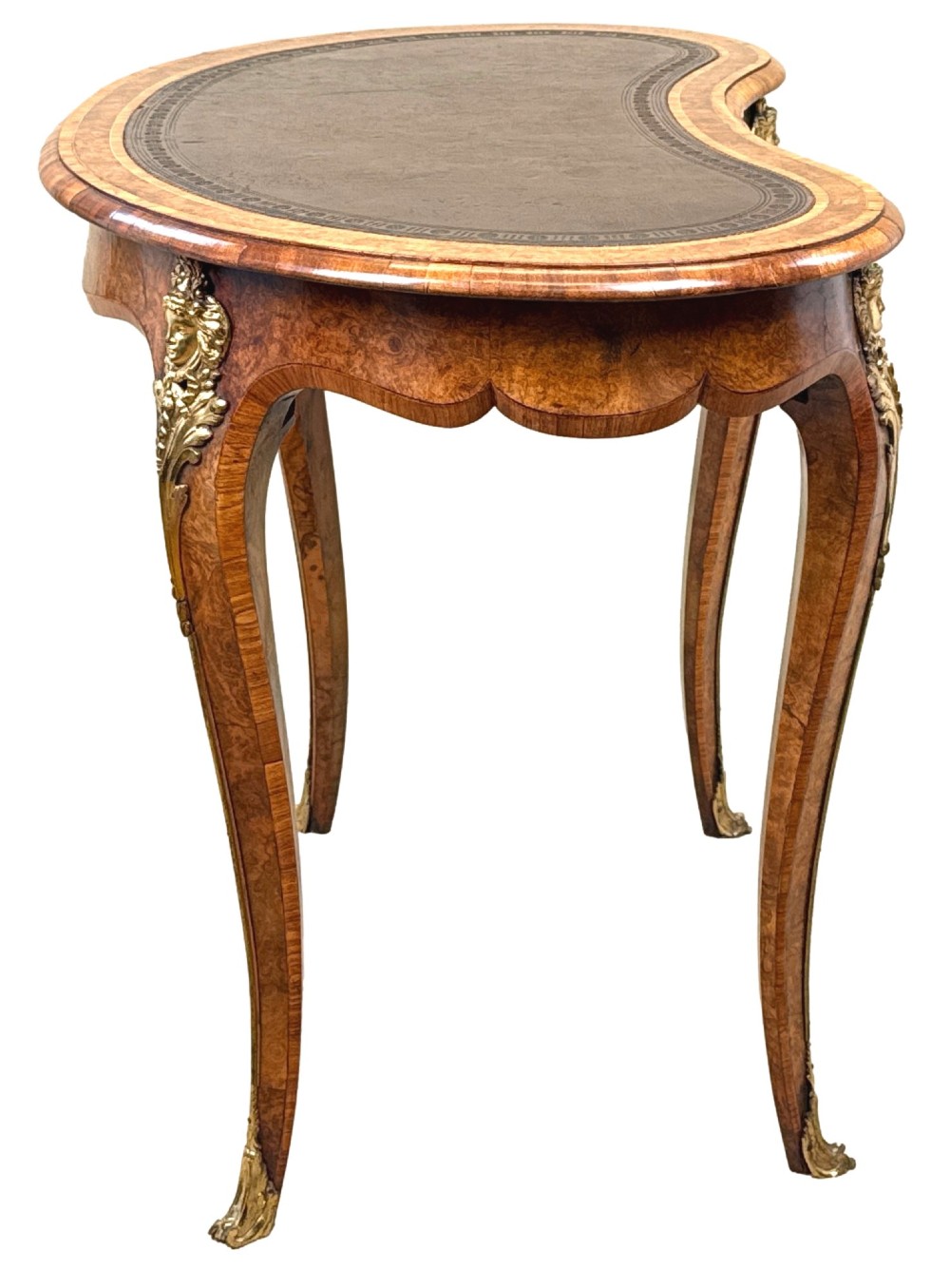 A 19th-century burr walnut kidney-shaped writing table featuring an inset leather top, gilt bronze espagnolette mounts, and cabriole legs. View IV