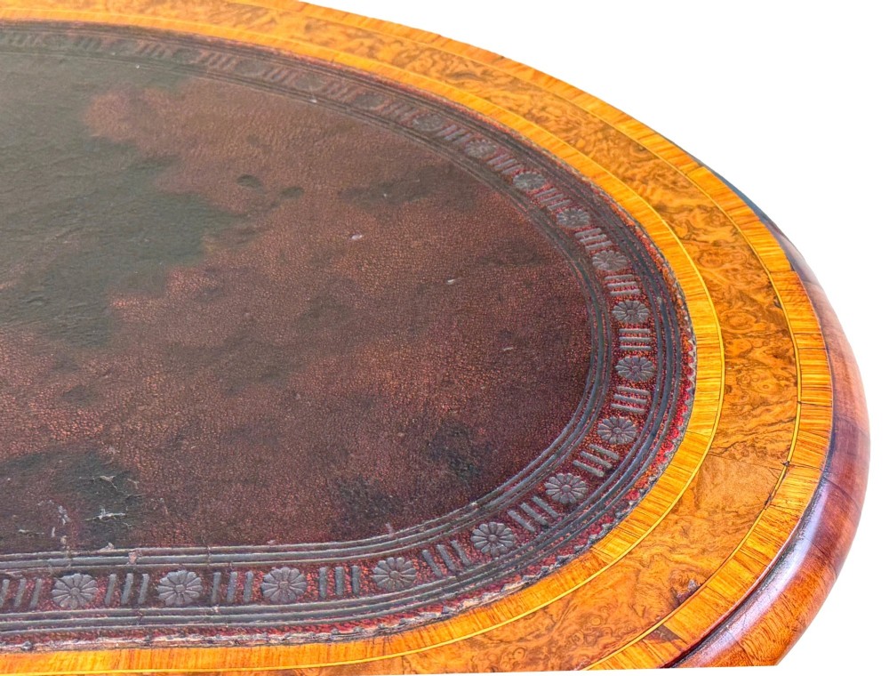 A 19th-century burr walnut kidney-shaped writing table featuring an inset leather top, gilt bronze espagnolette mounts, and cabriole legs. View IX