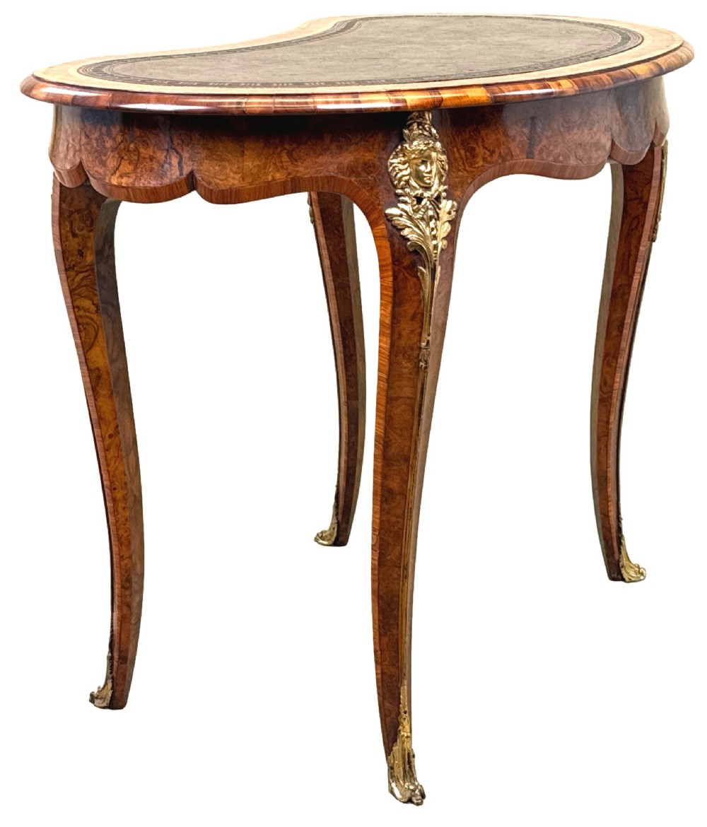 A 19th-century burr walnut kidney-shaped writing table featuring an inset leather top, gilt bronze espagnolette mounts, and cabriole legs. View XIII