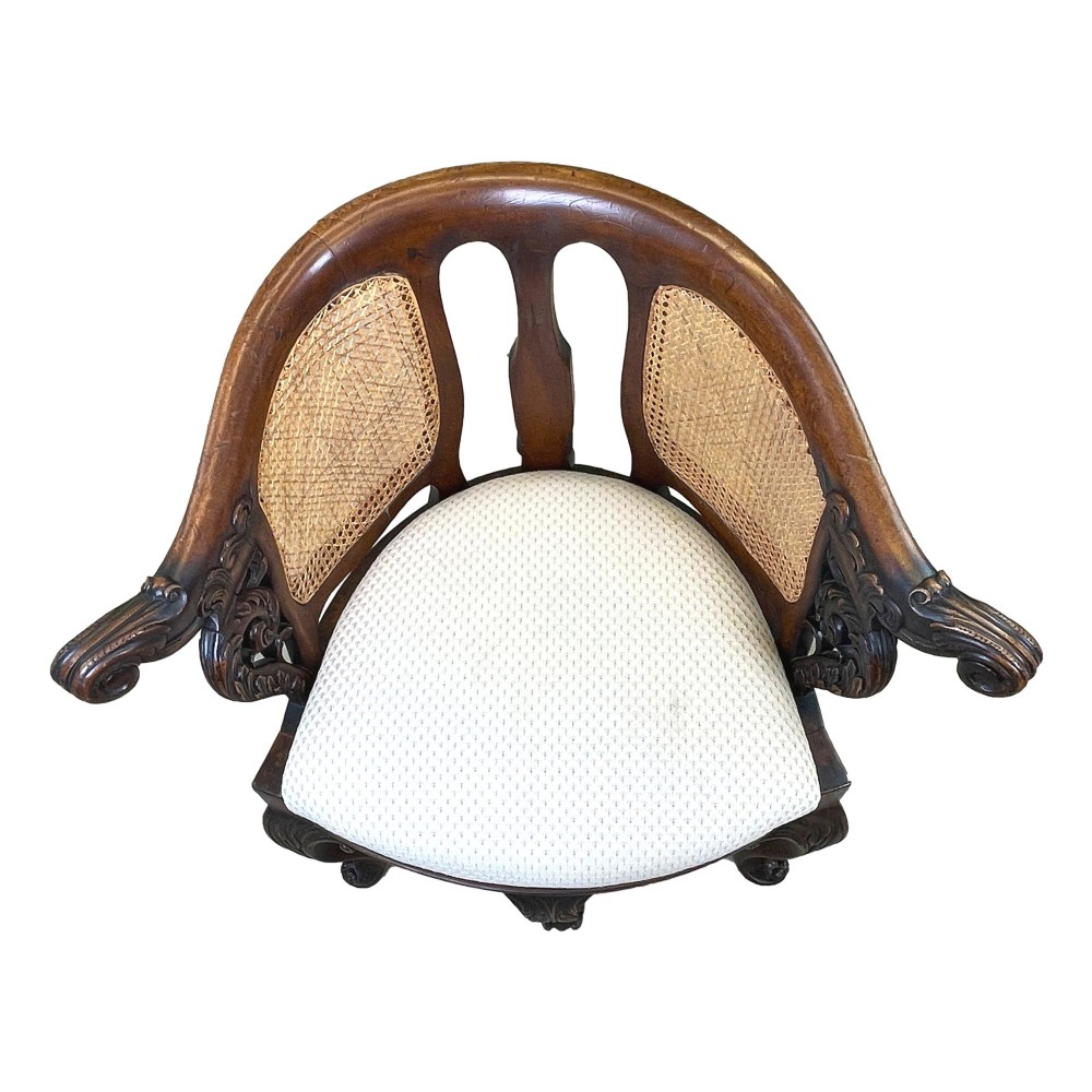A 19th-century mahogany Burgermeister desk chair featuring a curved backrest with woven cane panels, carved armrests, an upholstered cream seat, and cabriole legs. View III