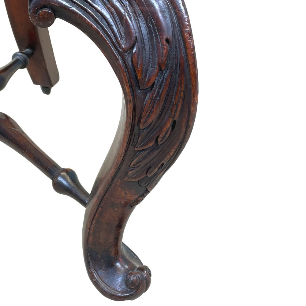 A 19th-century mahogany Burgermeister desk chair featuring a curved backrest with woven cane panels, carved armrests, an upholstered cream seat, and cabriole legs. View IV